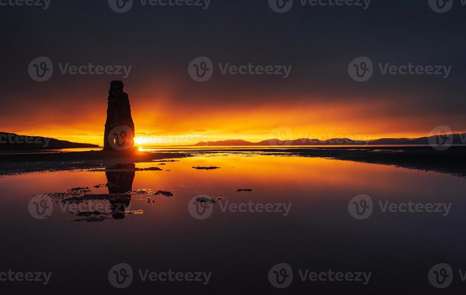 è una spettacolare roccia nel mare sulla costa settentrionale dell'Islanda. le leggende dicono che sia un troll pietrificato. in questa foto hvitserkur si riflette nell'acqua del mare dopo il tramonto di mezzanotte.