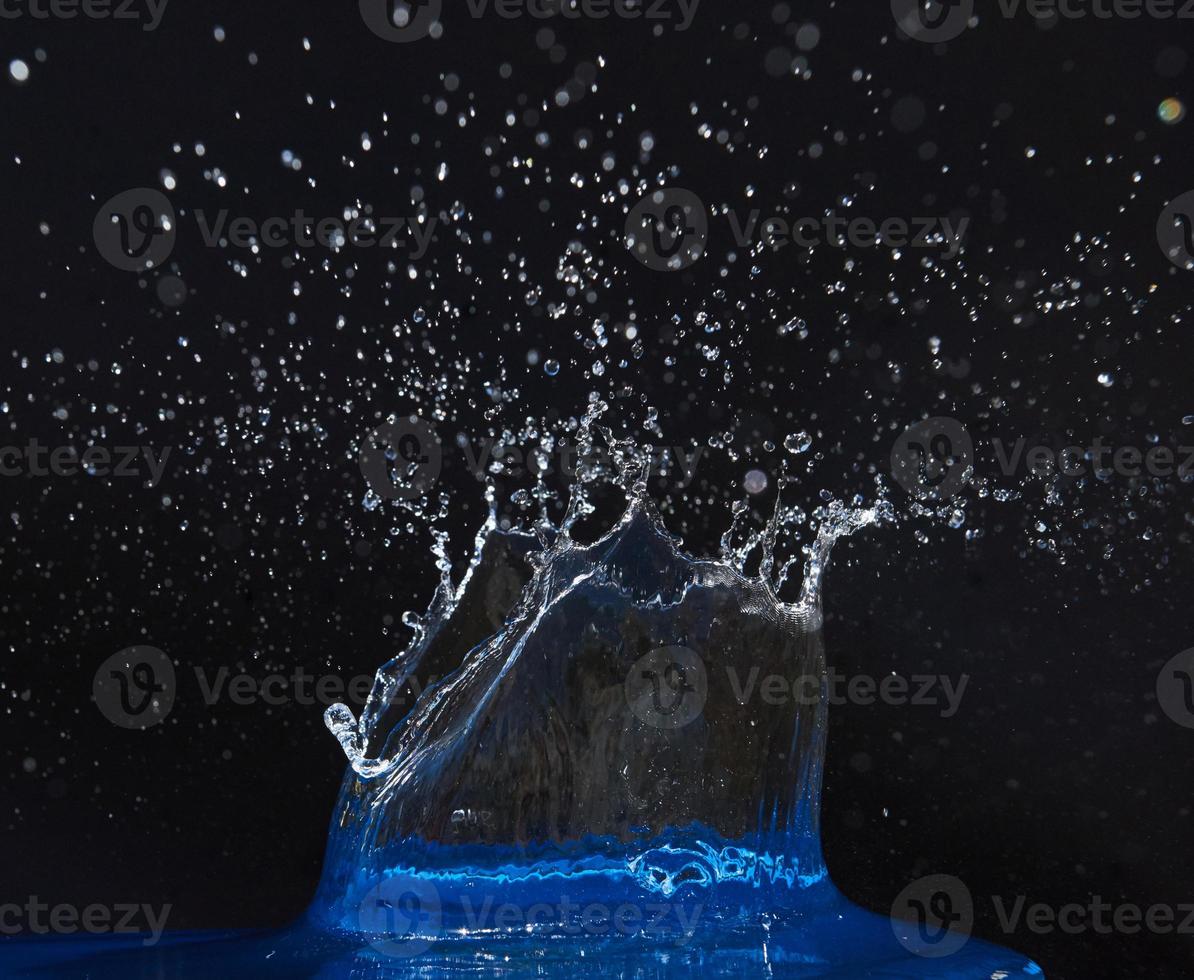 spruzzata di corona d'acqua sulla superficie blu. foto