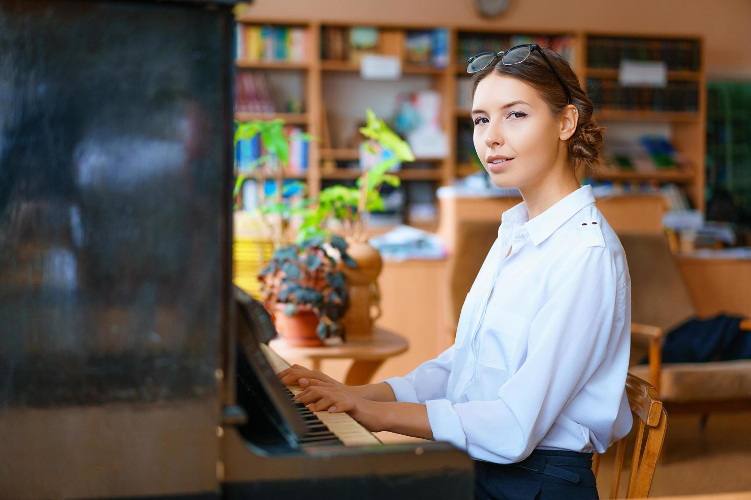 giovane donna che suona il pianoforte in ufficio foto