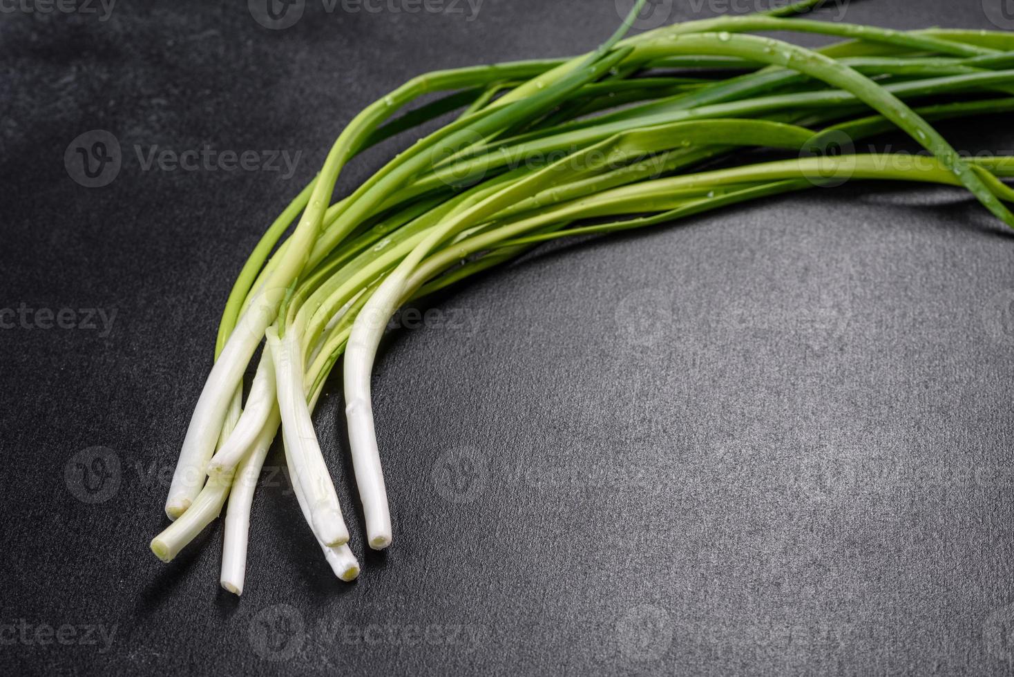 cipolla verde o scalogno su tavola di legno, erba cipollina fresca di primavera foto