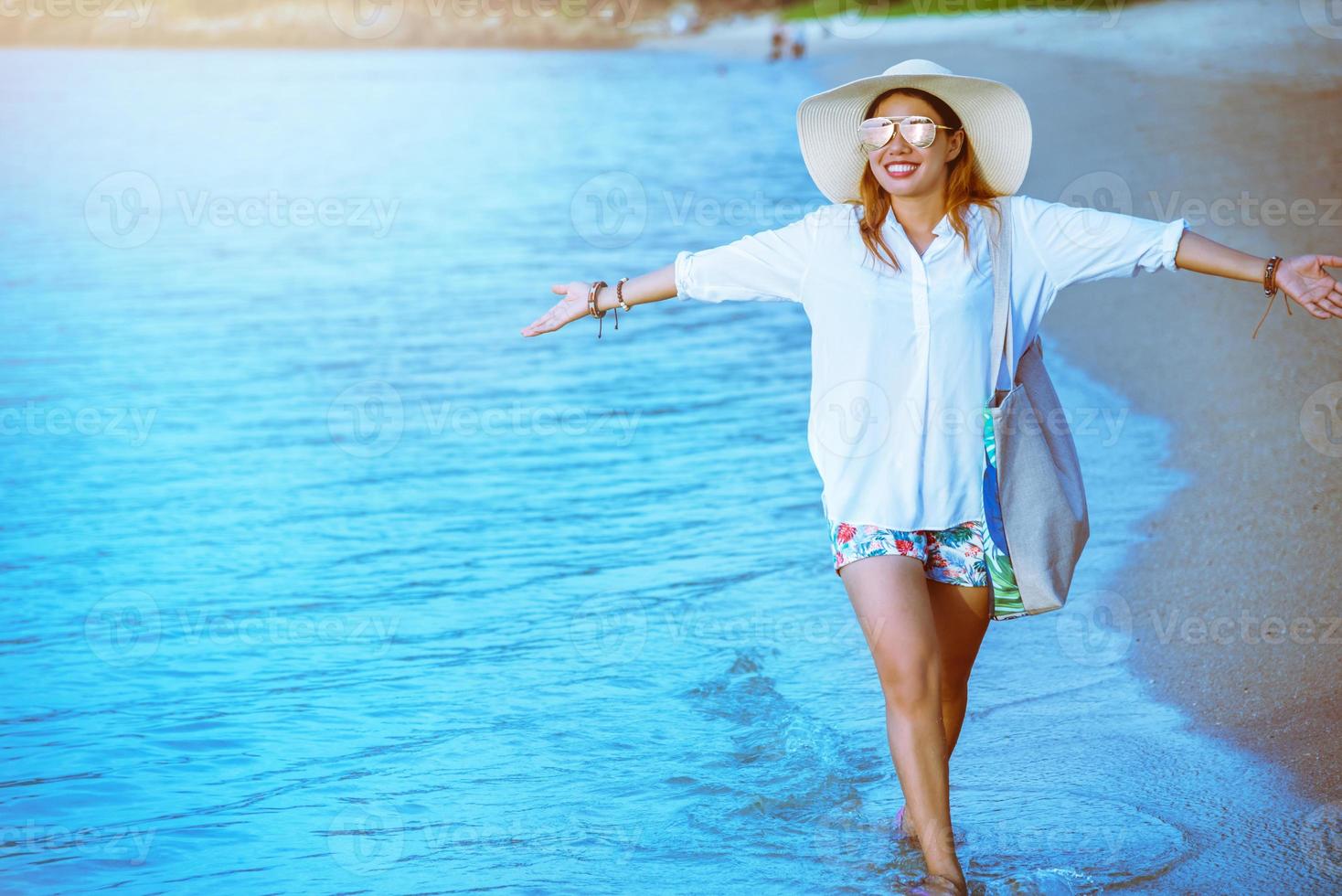 natura di viaggio donna asiatica. viaggiare rilassati. camminando sulla spiaggia. in estate foto