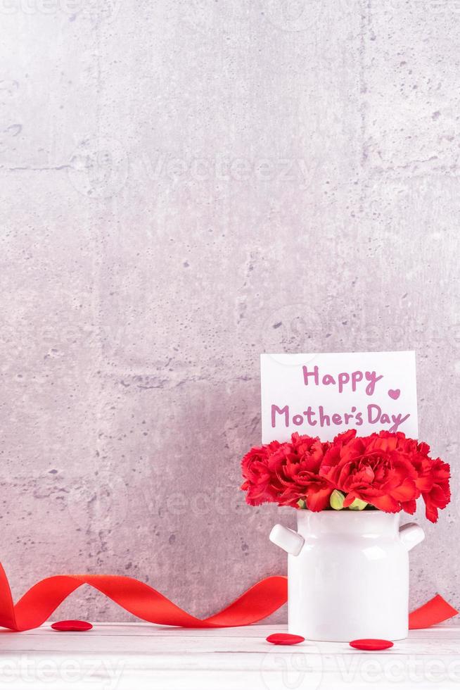può la festa della mamma confezione regalo fatta a mano desideri fotografia di design - bellissimi garofani in fiore in vaso isolato su sfondo grigio, tavolo in legno, primo piano, spazio per la copia, mock up foto