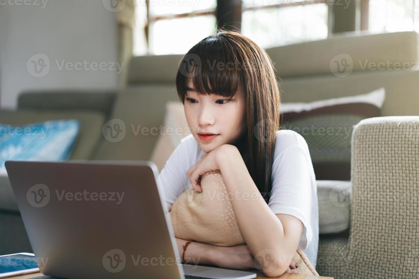 la donna asiatica dell'adolescente lavora e studia online via internet a casa. foto