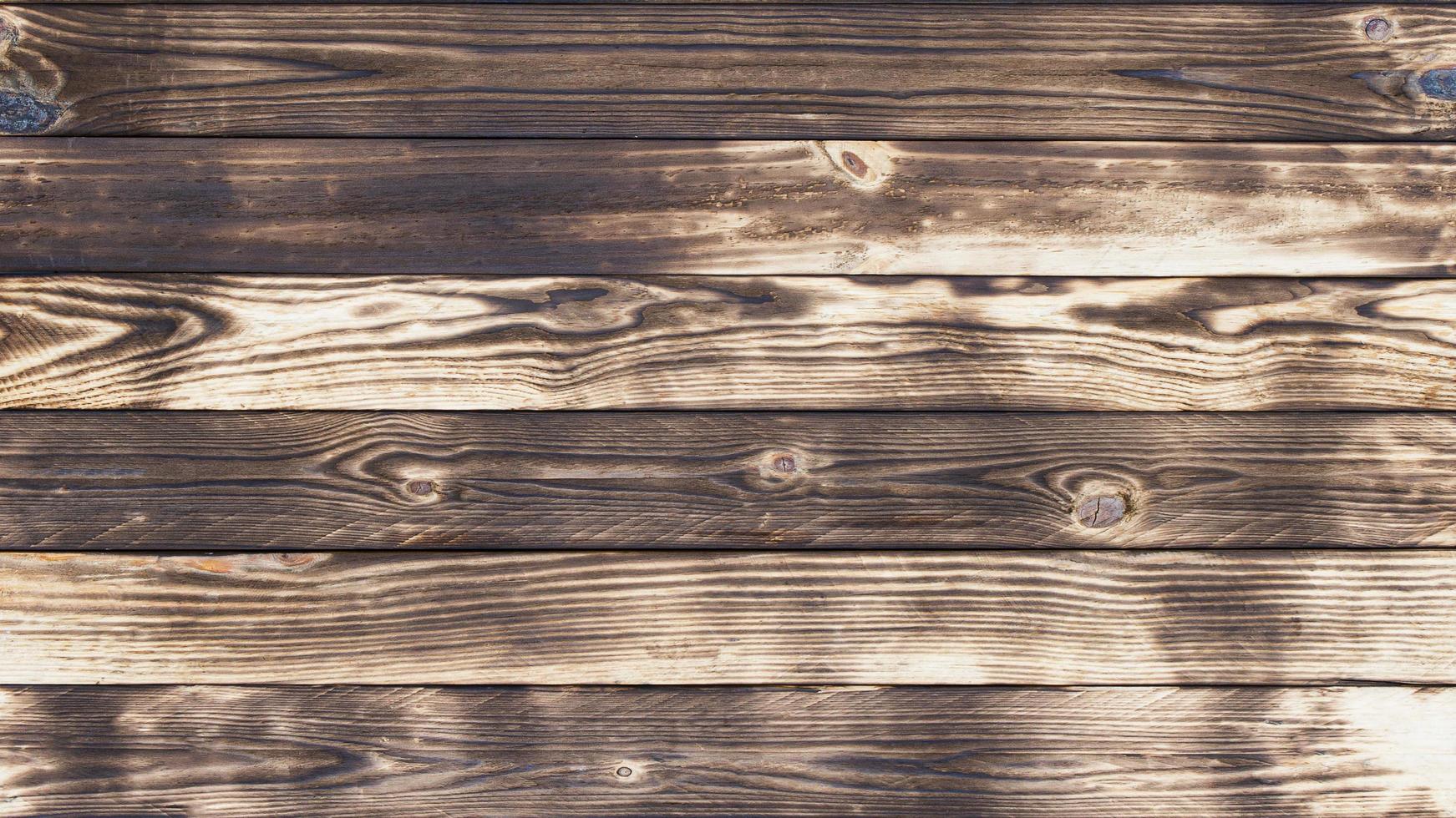 vecchi pavimenti in legno con tracce di nero bruciato su sfondi e texture astratte. foto