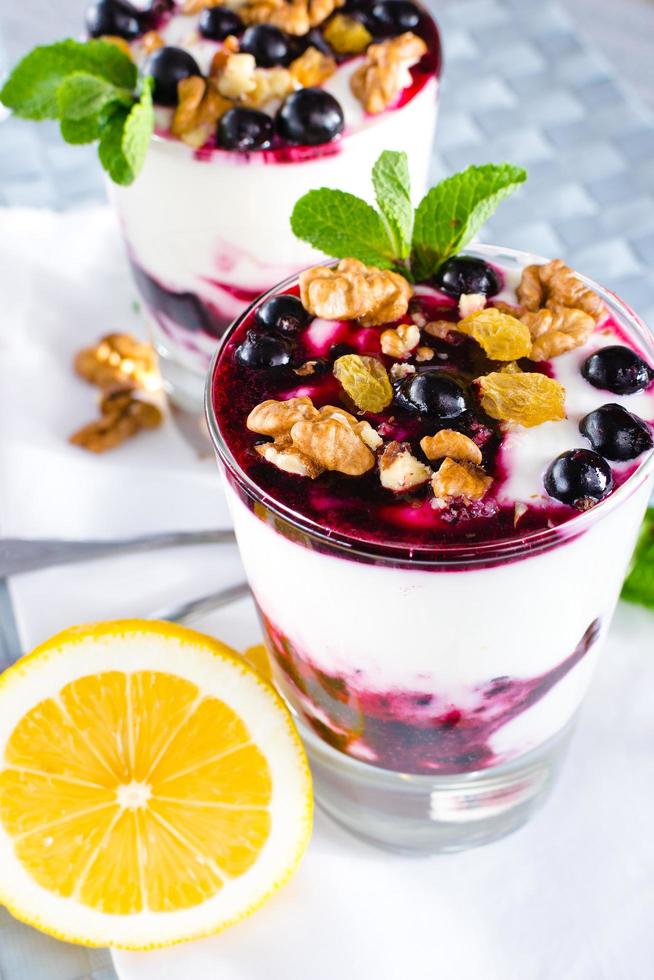 dessert alla crema con frutti di bosco, marmellata di ribes nero e noci decorato con foglie di menta foto