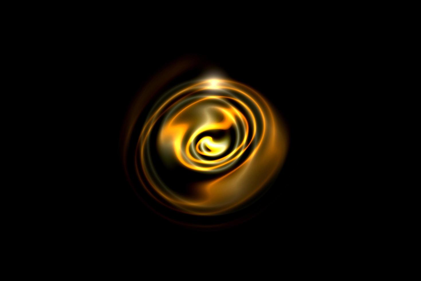 cerchio di fuoco astratto con spirale di luce dorata su sfondo nero foto