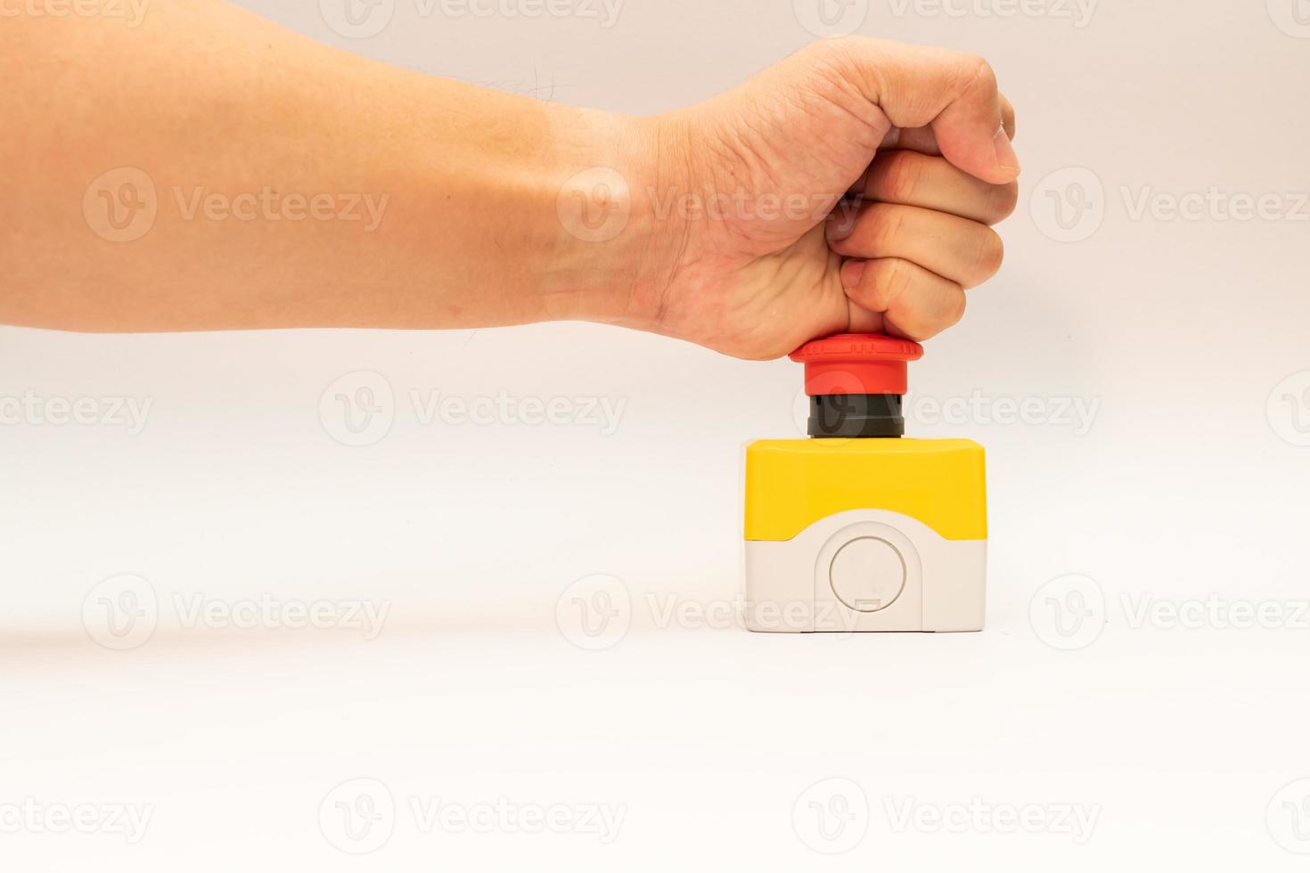 fermare il pulsante rosso e la mano del lavoratore che sta per premerlo. pulsante di arresto di emergenza. grande pulsante rosso di emergenza o pulsante di arresto per la pressione manuale. foto
