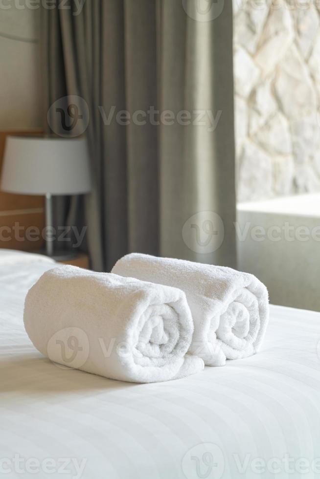 asciugamano bianco sul letto in camera da letto foto