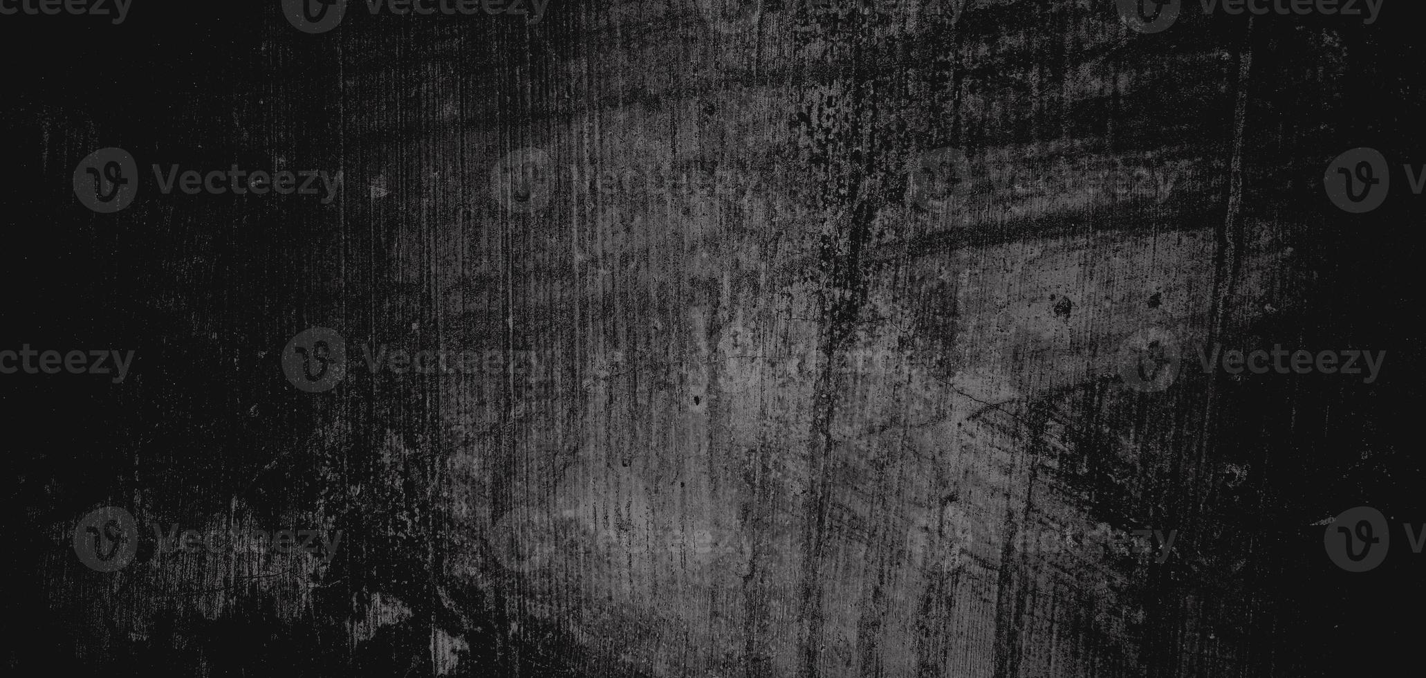 muro pieno di graffi. struttura di cemento grungy per sfondo, parete scura spaventosa. parete nera foto