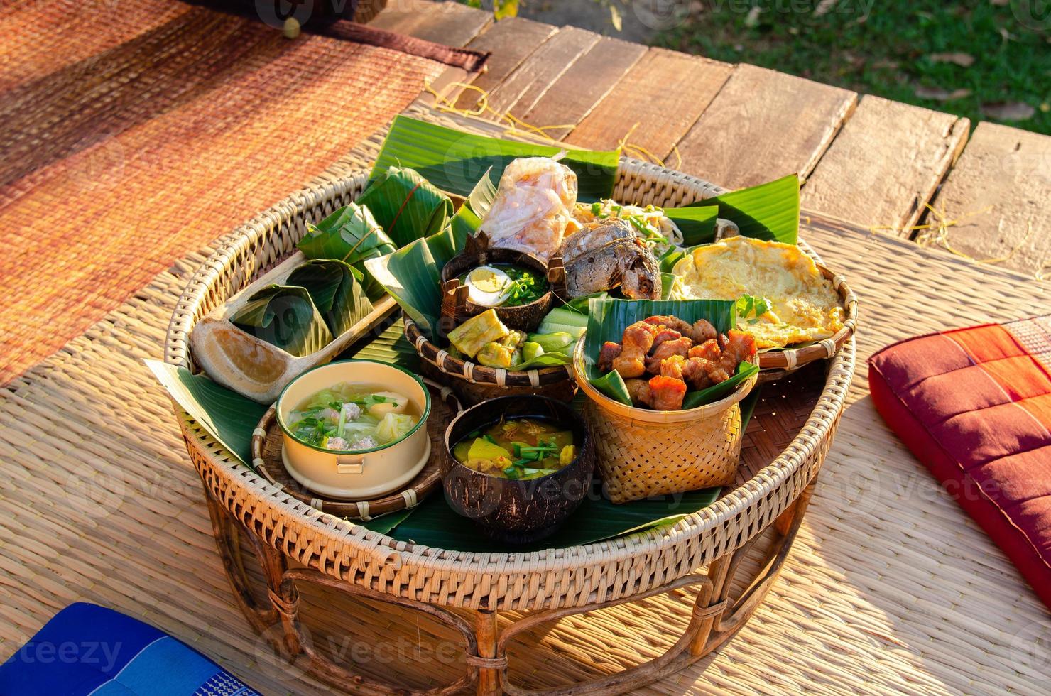 khantoke, è un vassoio con piedistallo utilizzato come piccolo tavolo da pranzo dal popolo lanna. una serie di piatti tradizionali tailandesi nel nord della thailandia e della campagna. foto