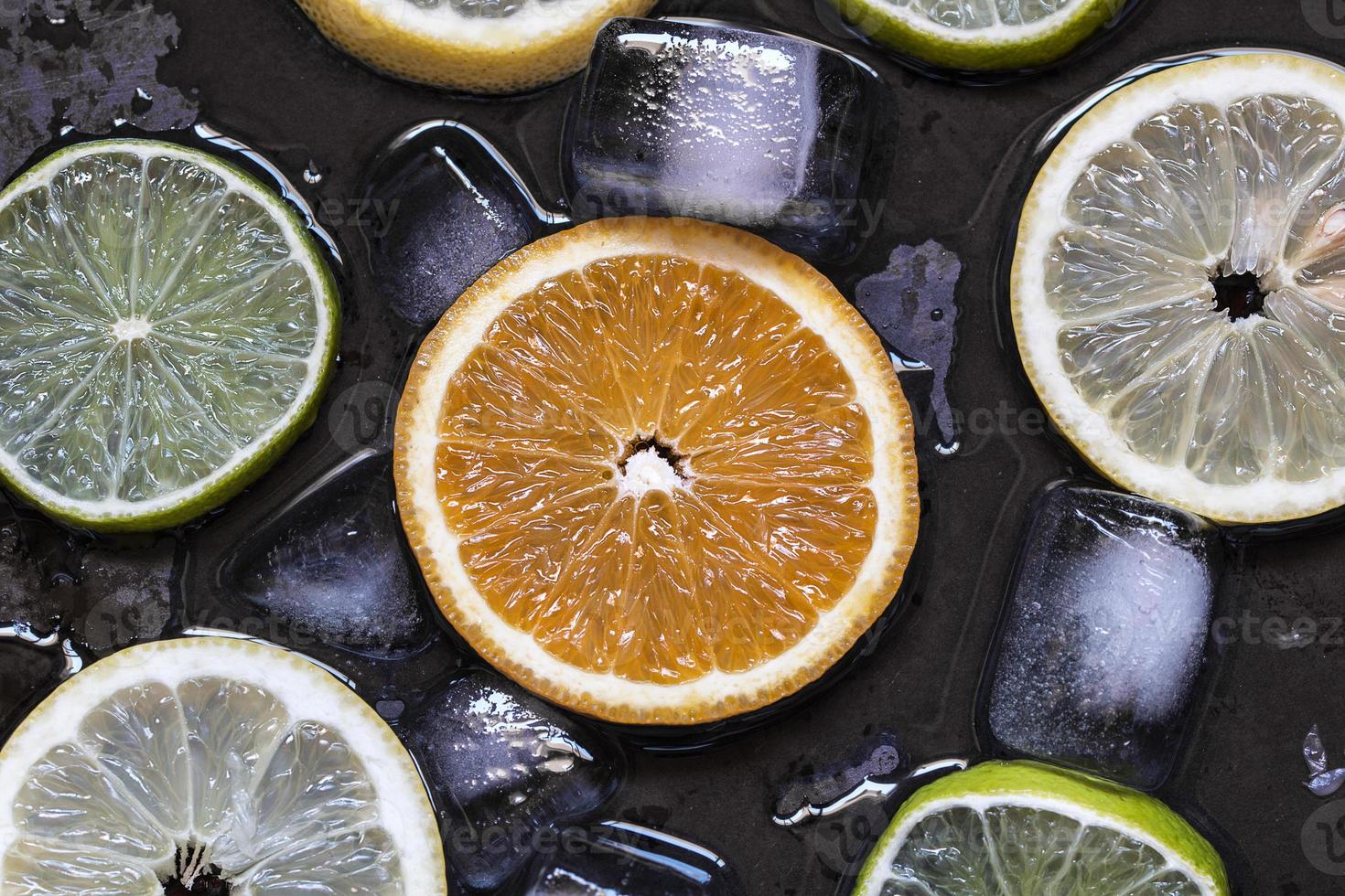 fette di agrumi limone, lime, arancia, pompelmo con ghiaccio ov foto