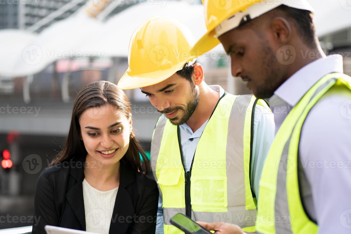 donna d'affari e lavoratore che discutono con l'ingegnere in cantiere. foto