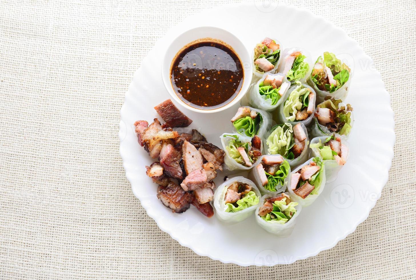 involtini primavera asiatici freschi e assortiti con carne di maiale alla griglia, verdure fresche. piatto sano e delizioso foto