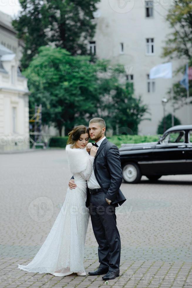 lo sposo in abito grigio e la sposa in abito grigio si guardano, ritratto in primo piano foto