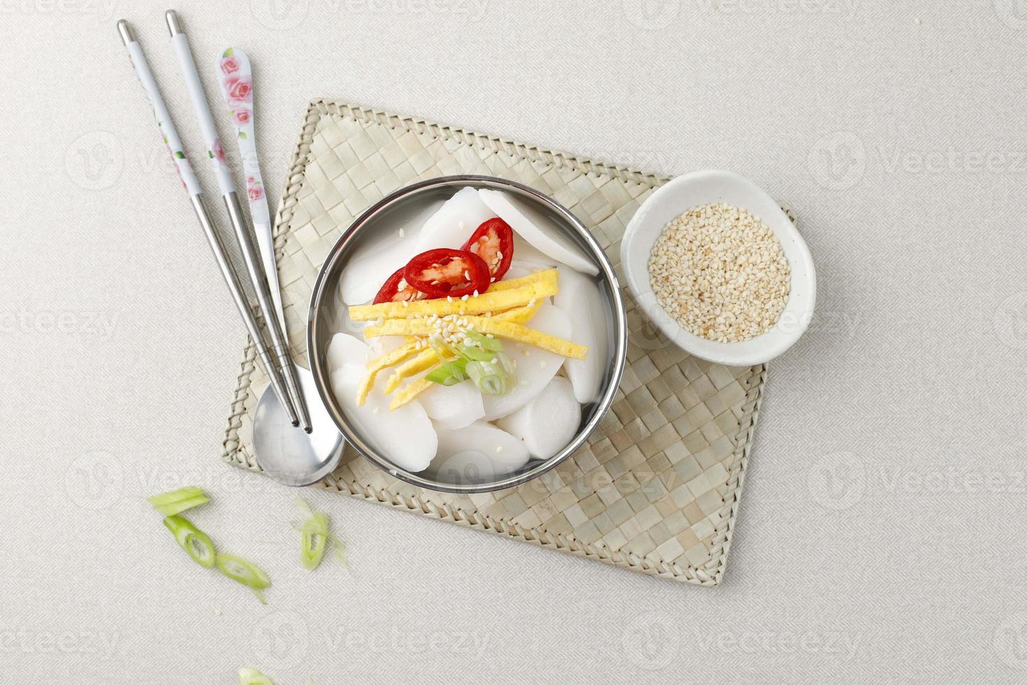 zuppa di torta di riso tteokguk cibo tradizionale coreano con cucchiai e bacchette, corea del sud foto