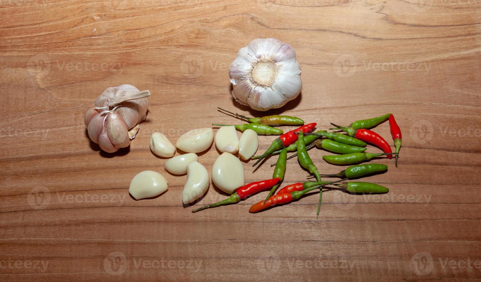 aglio bianco e peperoncino sul pavimento di legno per cucinare foto