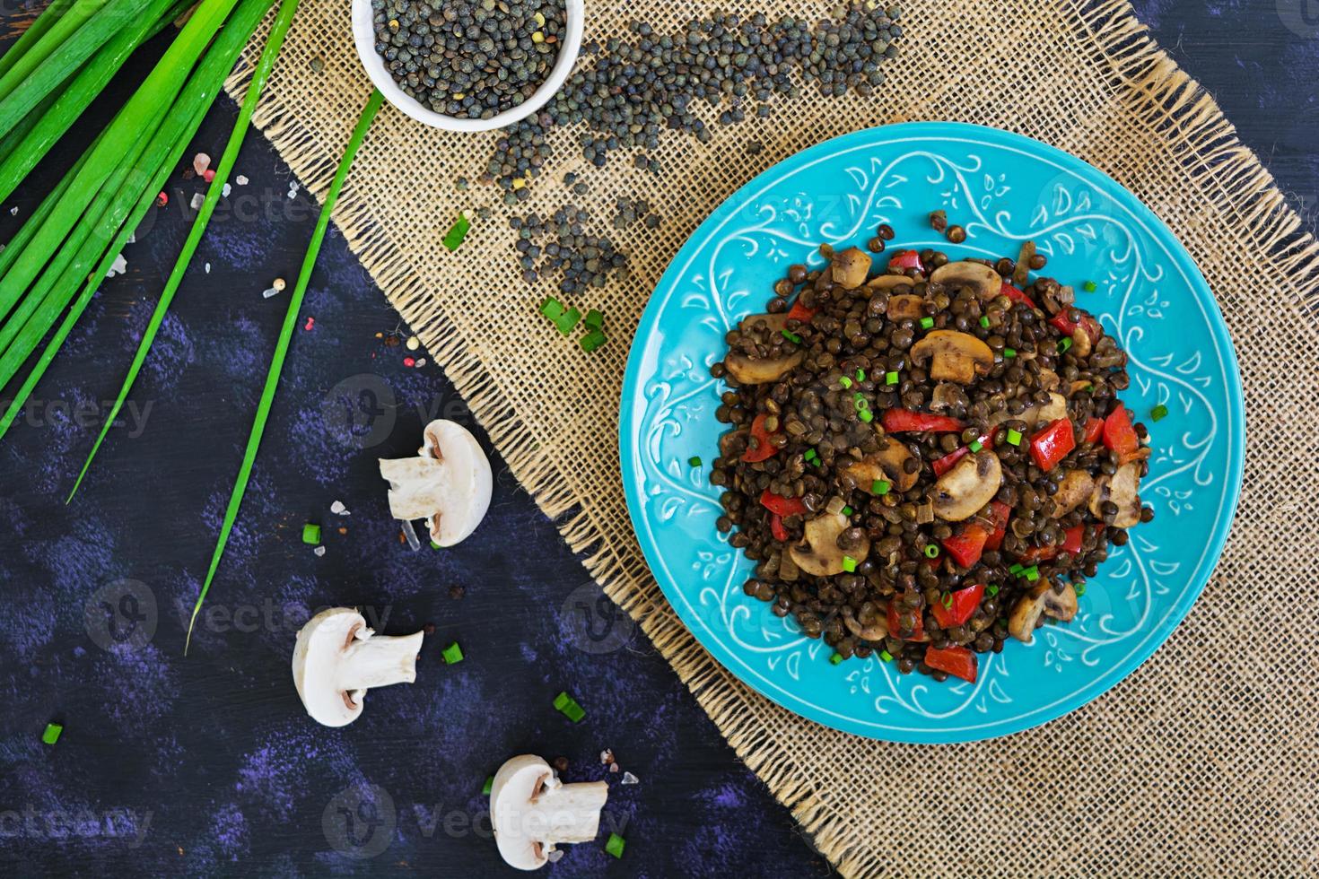 deliziose lenticchie con pepe e funghi su sfondo scuro foto