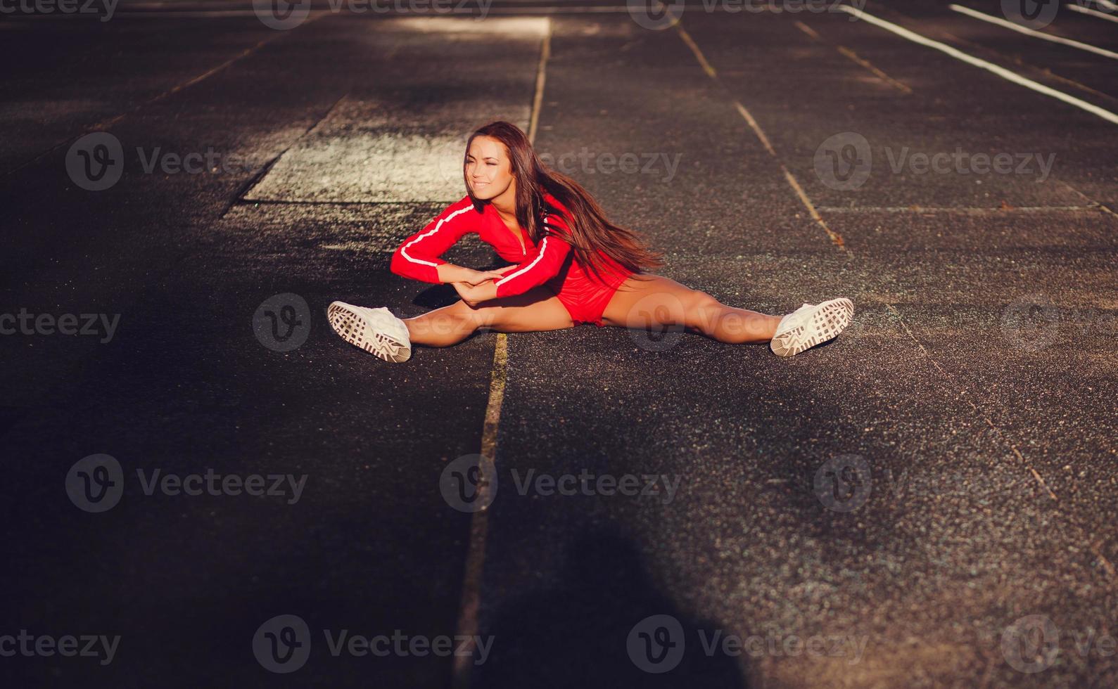 corridore femminile che fa stretching foto