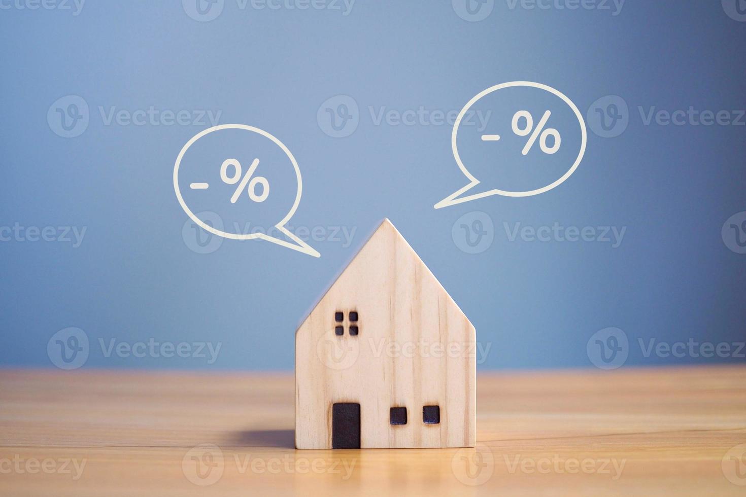 casa in legno e icona percentuale, concetto di tasso di interesse finanziario e concetto di tasso ipotecario della casa in legno. foto