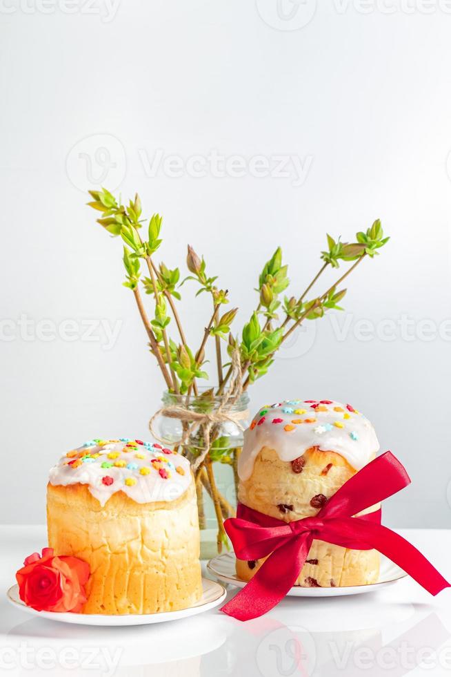 deliziose torte pasquali decorate con nastro e fiori su sfondo bianco. foto