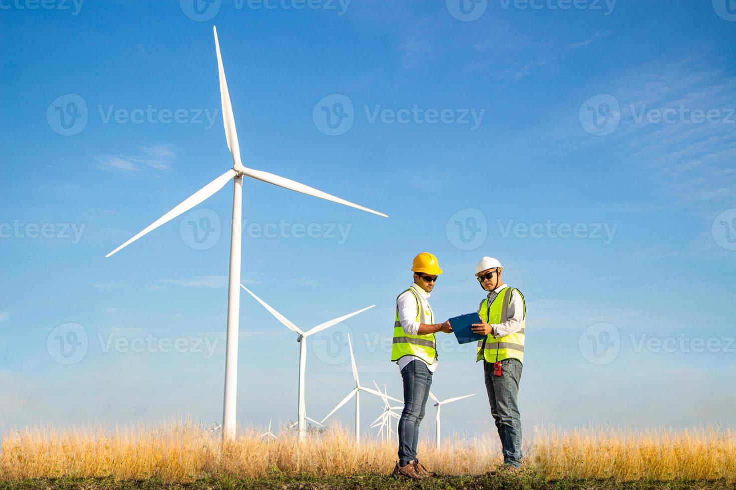 team di ingegneri che lavora nella fattoria di turbine eoliche. energia rinnovabile con generatore eolico dal concetto di energia alternativa. foto