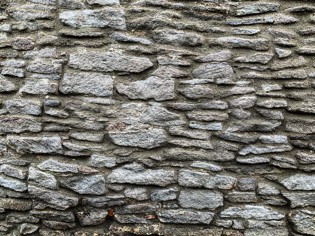 vecchio muro di pietra sullo sfondo. fondale in pietra foto