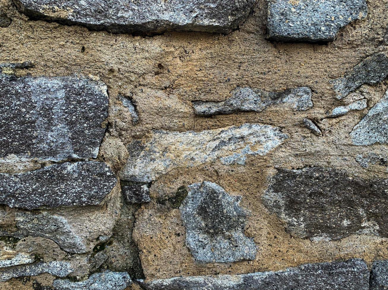 vecchio muro di pietra sullo sfondo. fondale in pietra foto