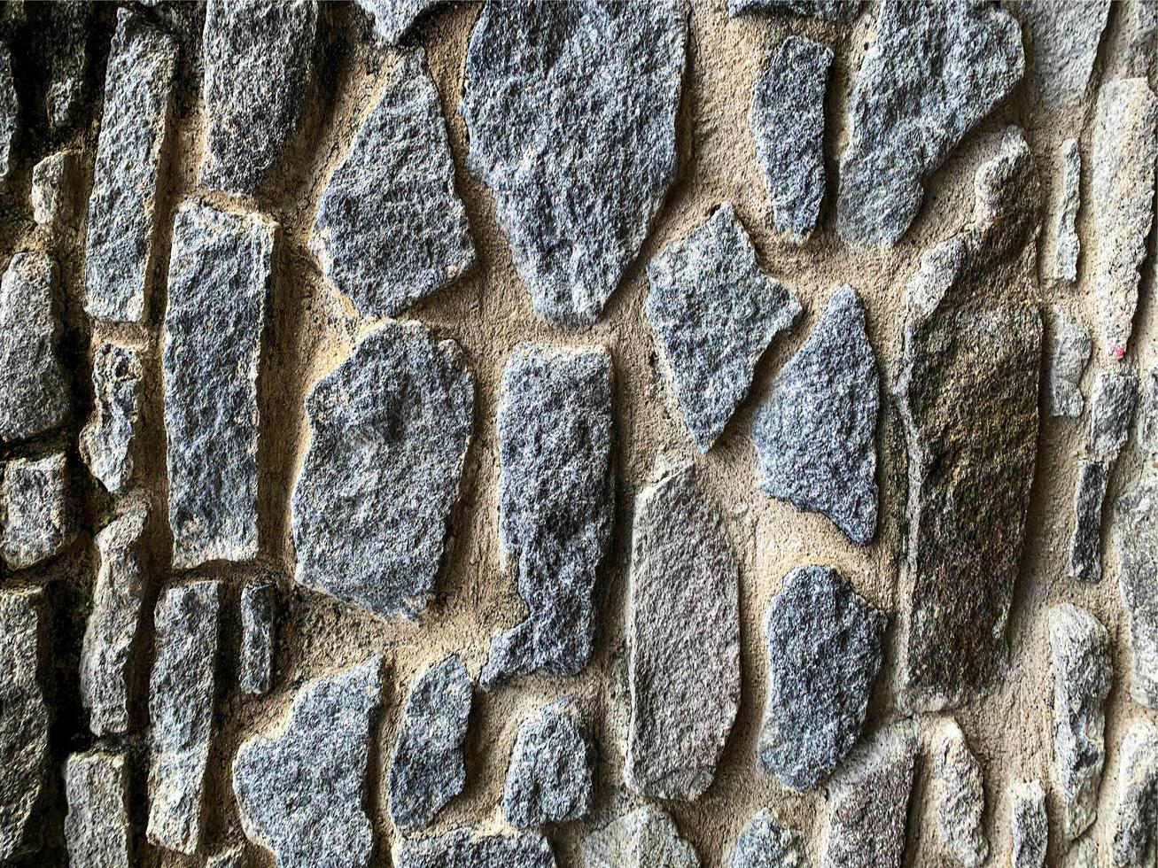 vecchio muro di pietra sullo sfondo. fondale in pietra foto