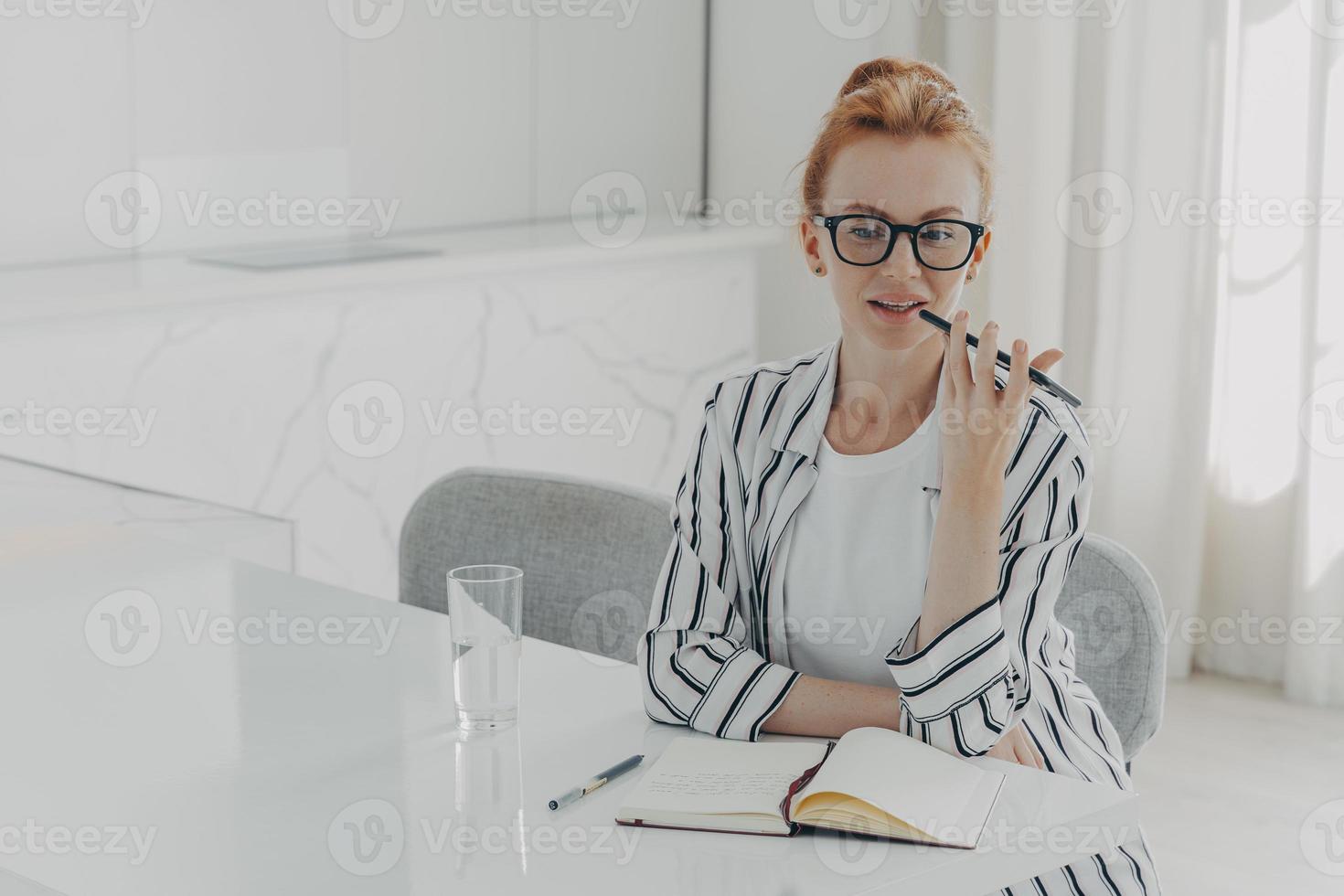 la foto della giovane donna rossa registra la chiamata vocale tramite il microfono dello smartphone si trova sul desktop