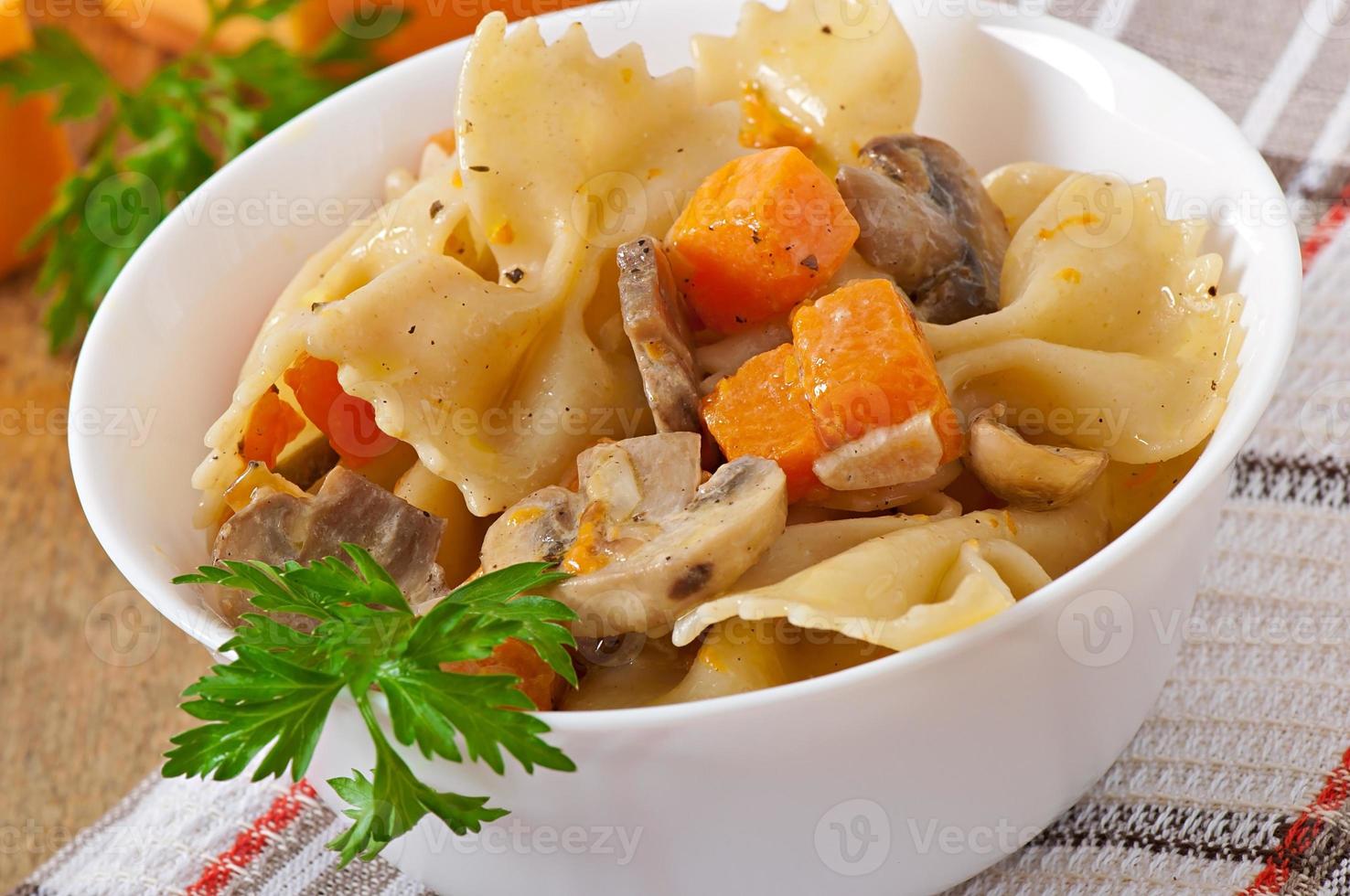 pasta in salsa di panna con fettine di zucca e funghi foto