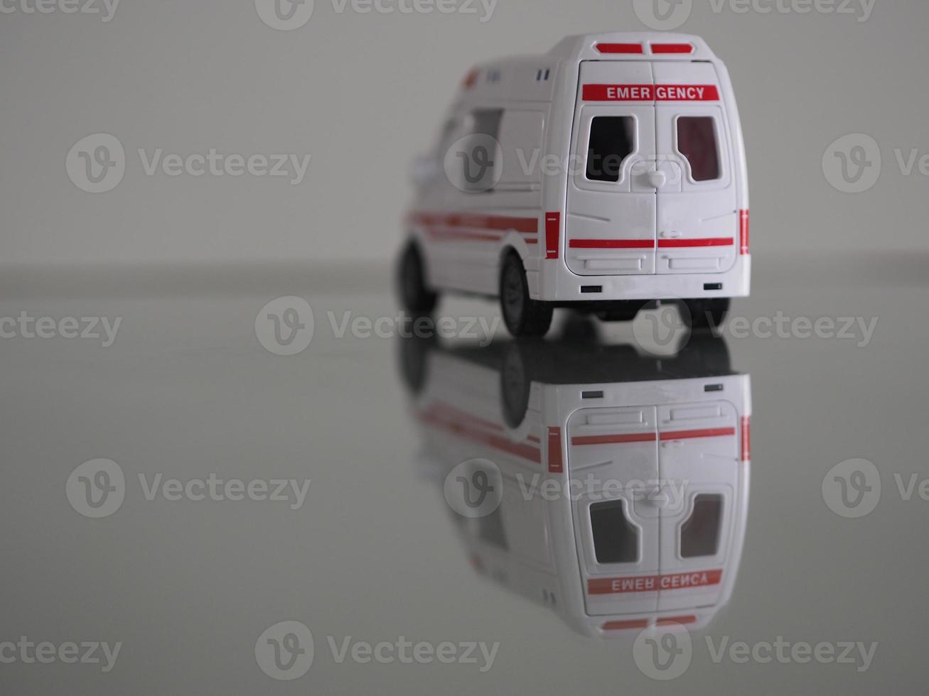ambulanza modello di emergenza auto di colore bianco sulla riflessione del tavolo dello specchio foto
