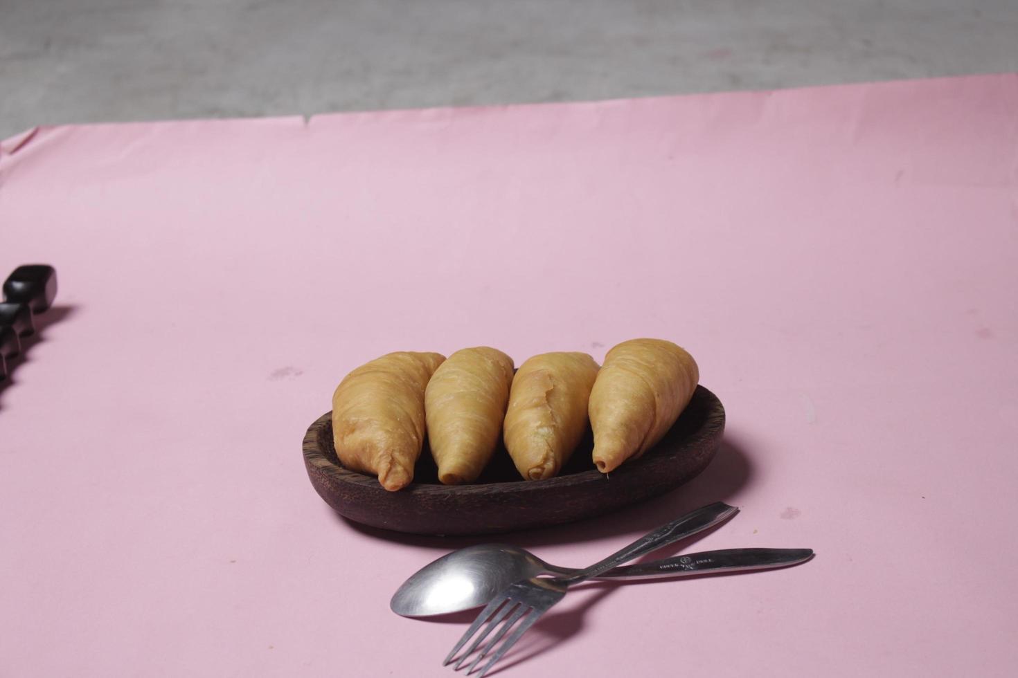 torta salata molen banana per spuntini da accompagnare al menù della colazione. le banane molen con pasticcini vengono solitamente servite con una tazza di caffè o tè caldo. spuntini del mercato. sfocatura della messa a fuoco. concentrati su alcuni angeli. foto