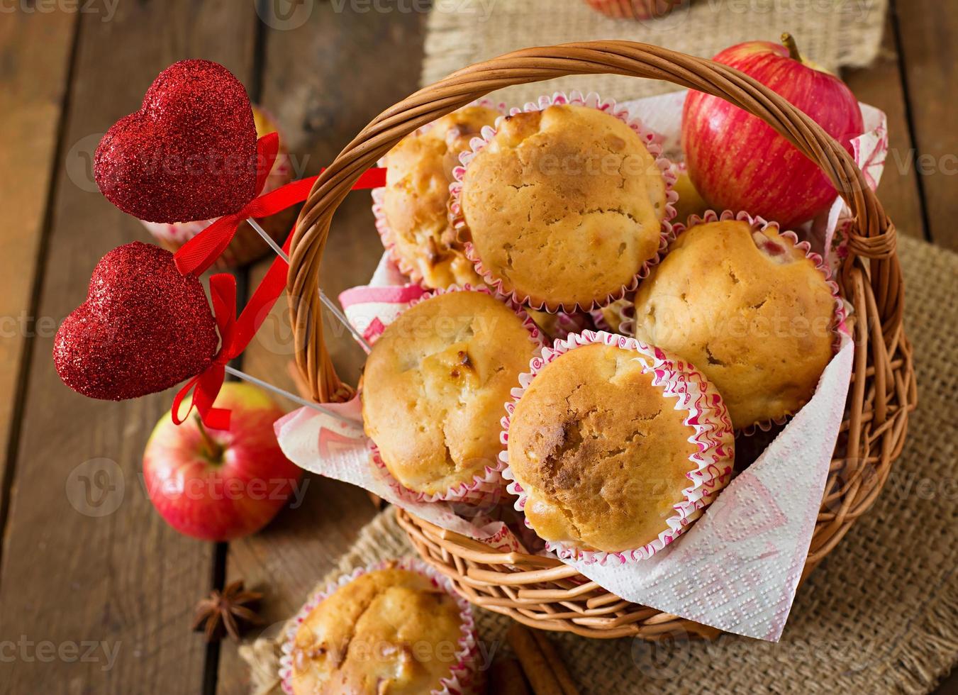 muffin alla frutta con noce moscata e pimento in un cesto di vimini su uno sfondo di legno foto