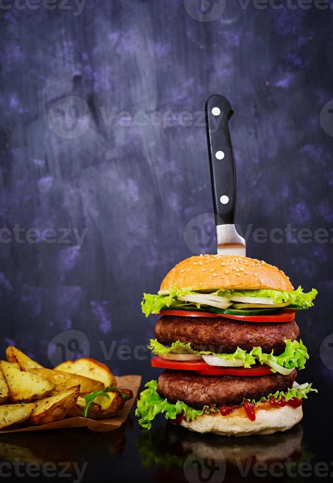 delizioso hamburger fatto a mano su sfondo scuro. vista ravvicinata foto