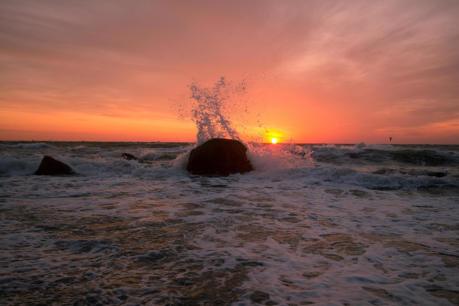 bellissimo paesaggio marino all'alba, cielo colorato rosa e arancione e tempesta nel mare. foto