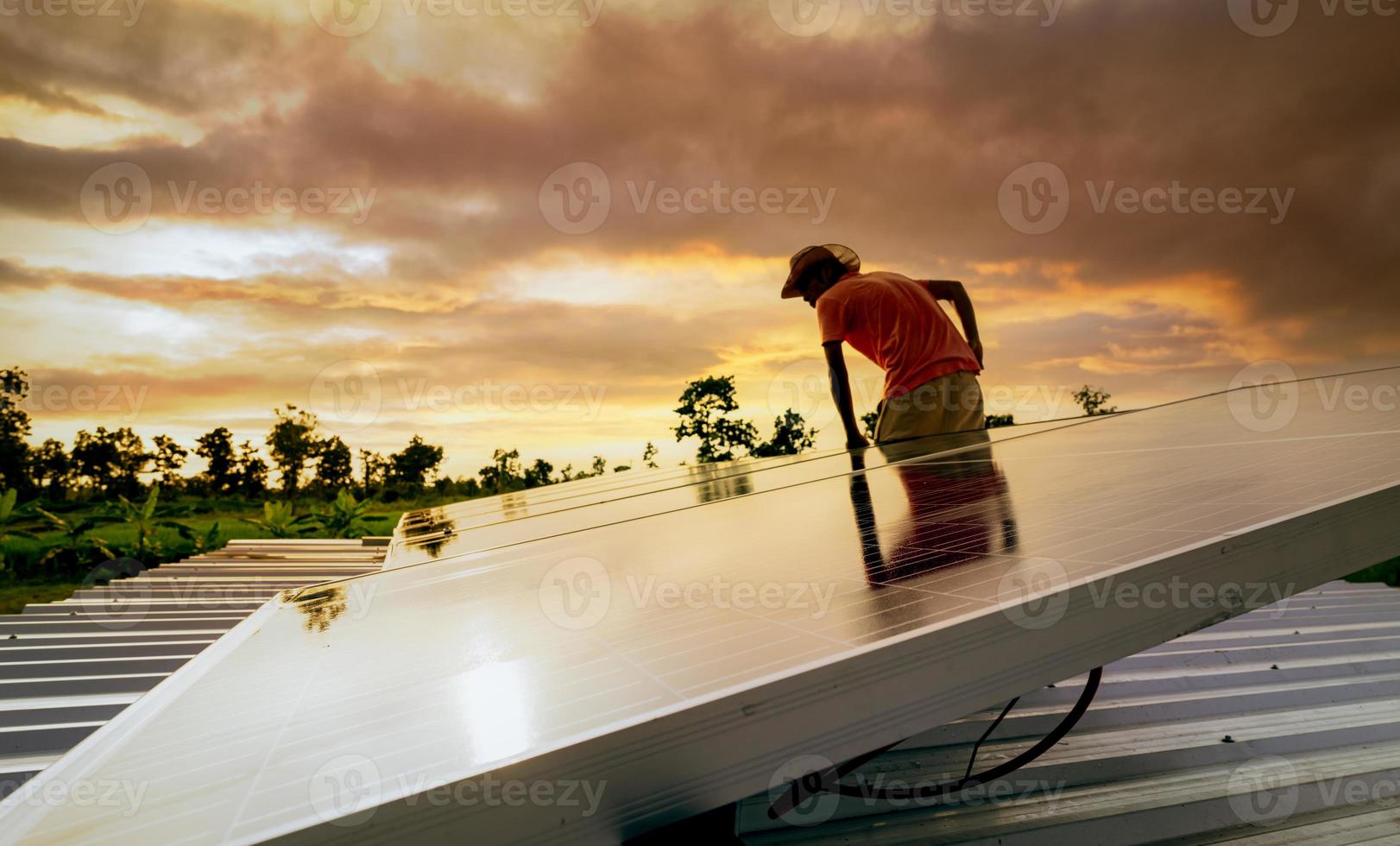 uomo che controlla il pannello solare sul tetto per sicurezza. manutenzione di pannelli solari o moduli fotovoltaici. risorsa sostenibile ed energia rinnovabile. energia solare per l'energia verde. stile di vita sostenibile. potere pulito foto