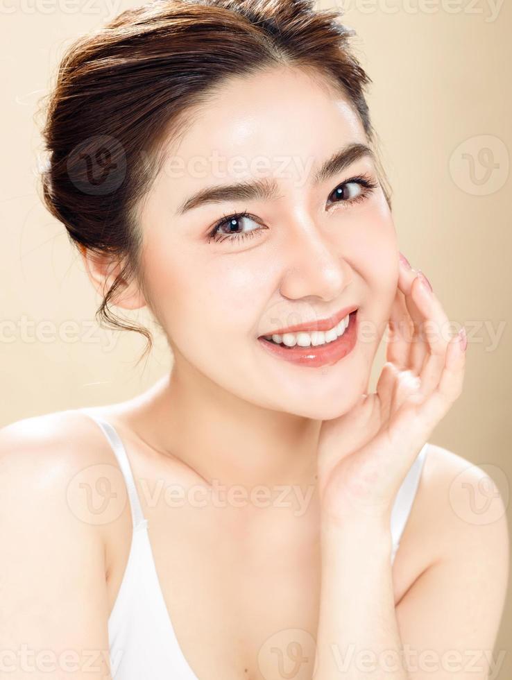 la donna asiatica con un bel viso e una pelle fresca e liscia è vestita di rosa. foto