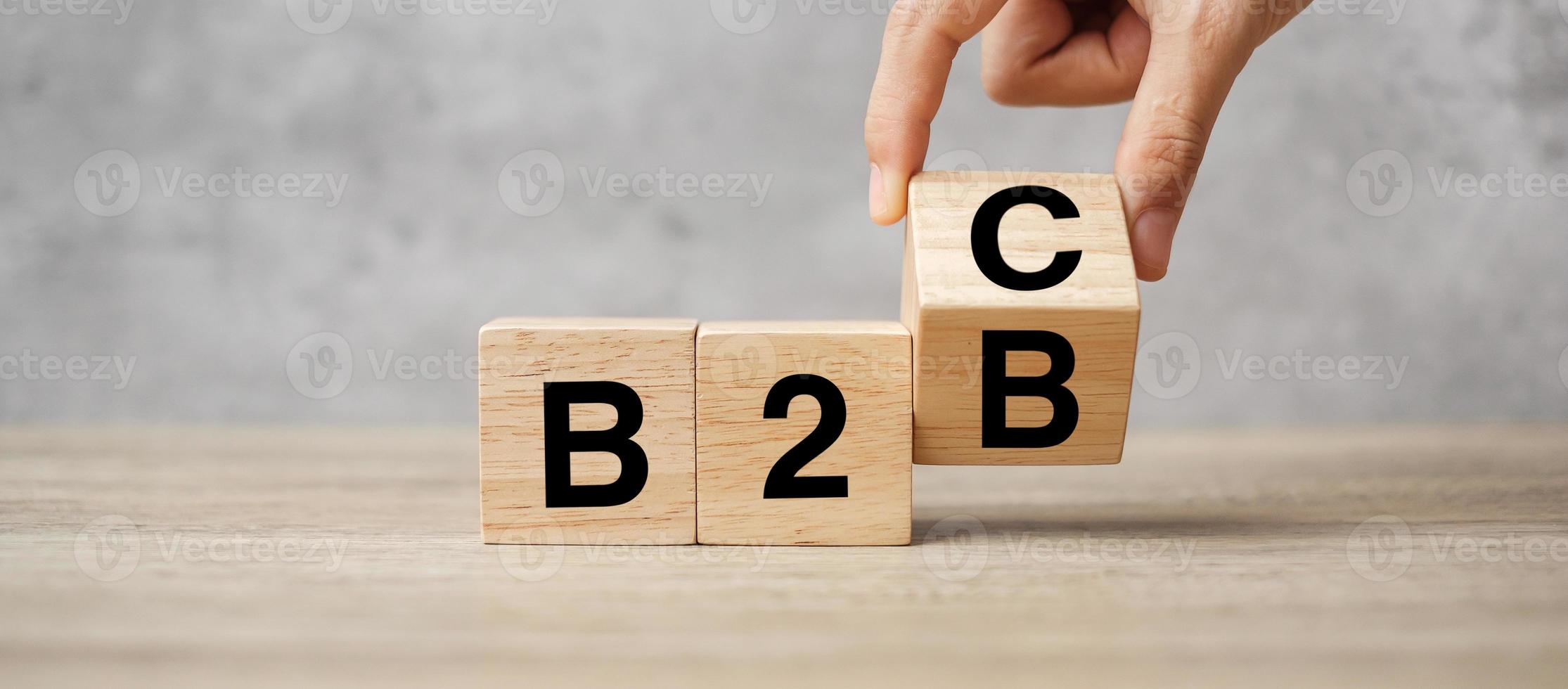 cambia a mano il cubo di legno da b2c a b2b. concetti di e-commerce, marketing e strategia foto