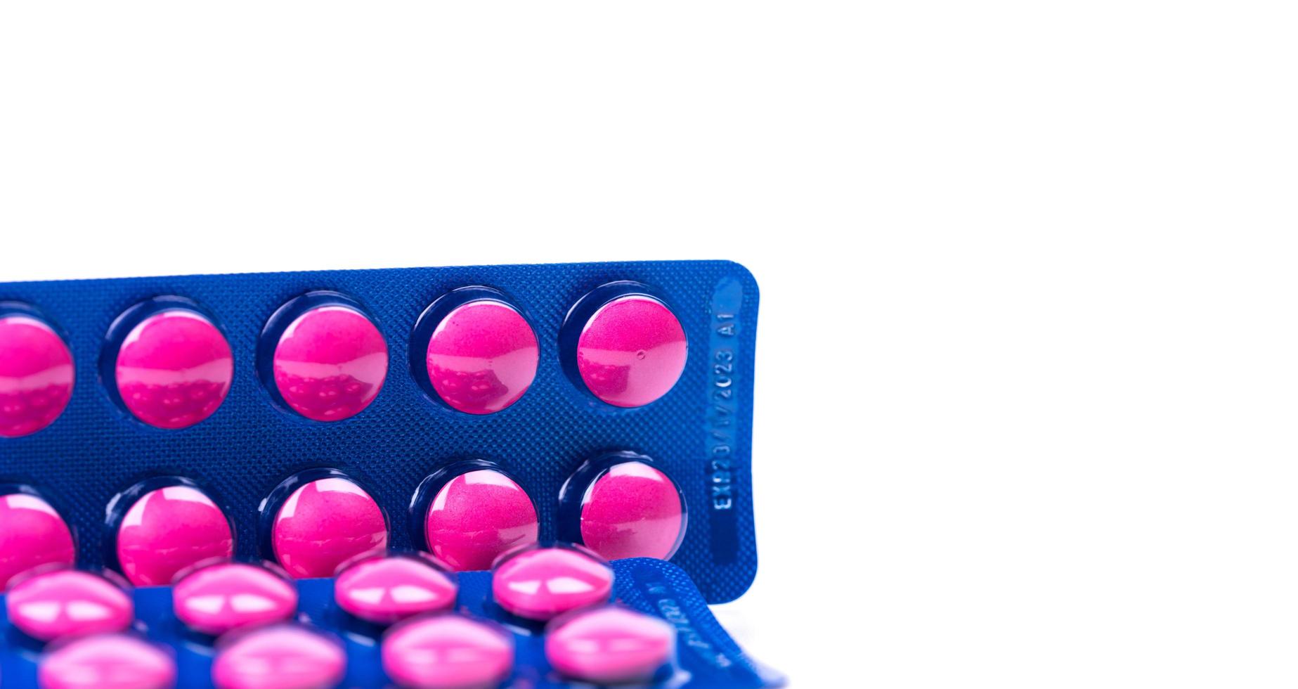 compresse rosa pillola in blister blu isolato su sfondo bianco. medicinale antidolorifico. industria farmaceutica. medicinale per il trattamento di emicrania, febbre, mal di denti. prodotti della farmacia della farmacia. foto