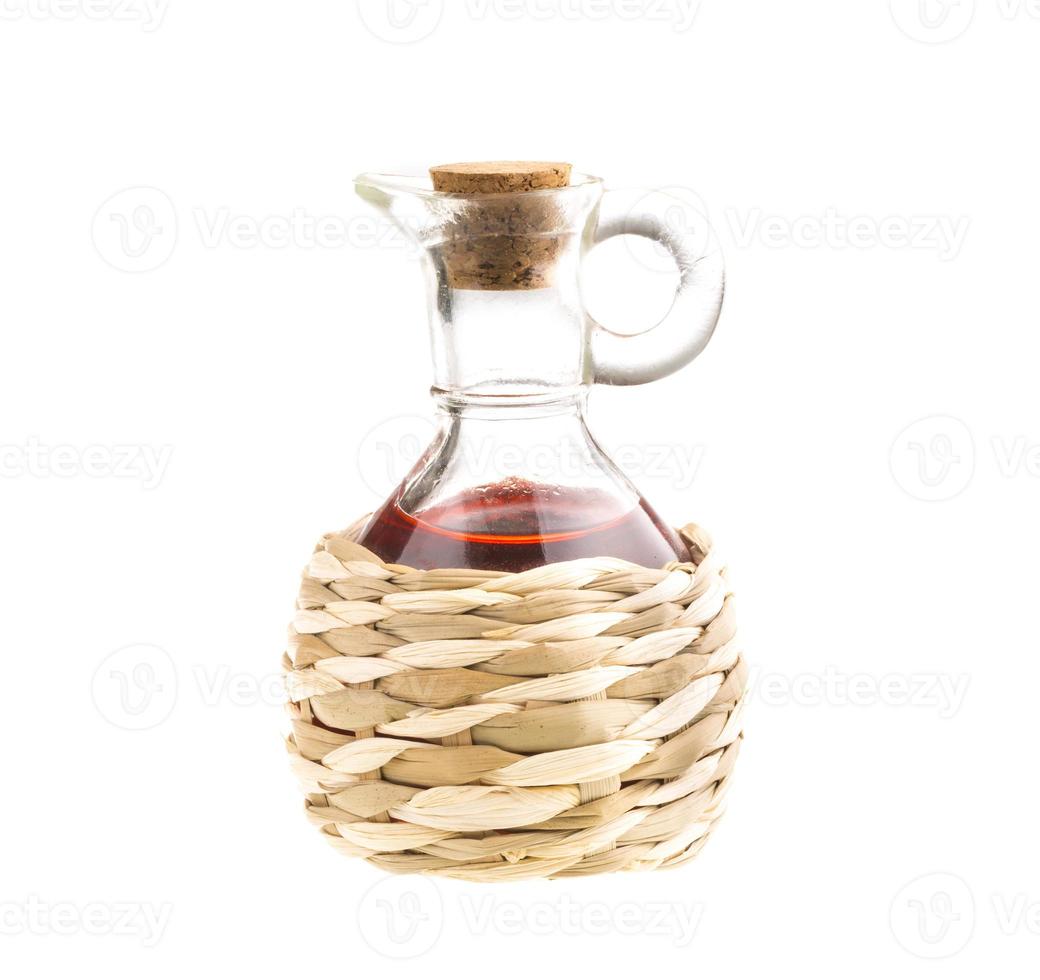 piccolo decanter con aceto di vino rosso isolato sul bianco foto