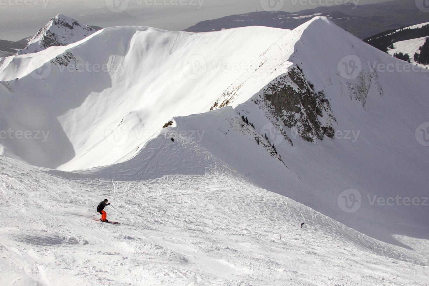 maschio che indossa pantaloni rossi sciare nelle Alpi svizzere foto