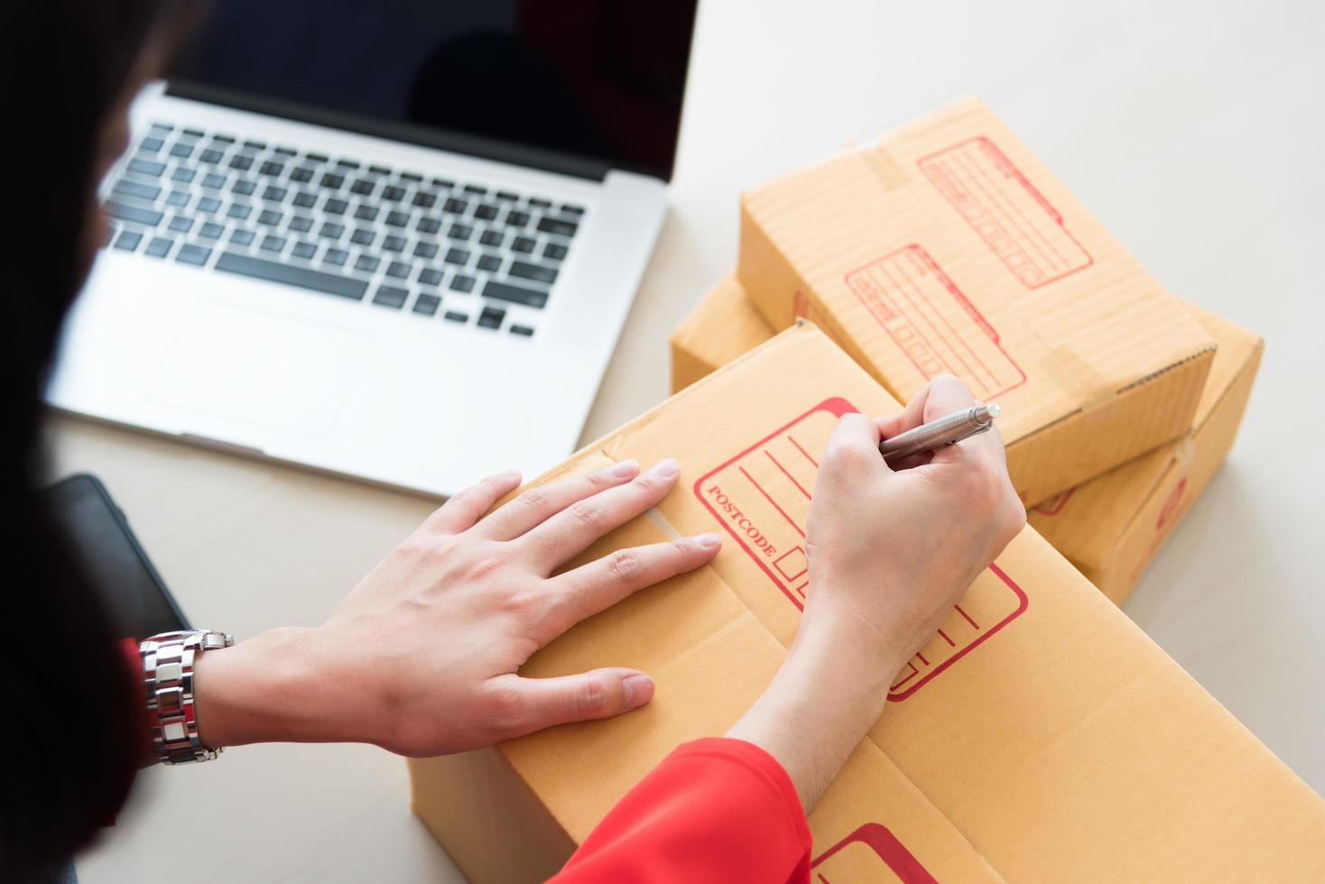 le giovani donne stanno preparando un pacco per la consegna ai clienti. foto