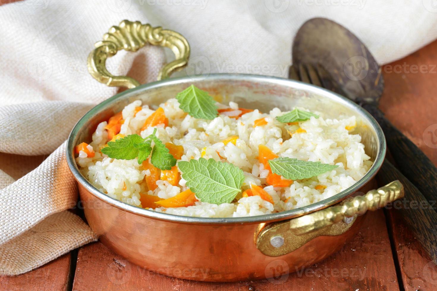 riso con verdure cotte in stile indiano in una padella di rame foto