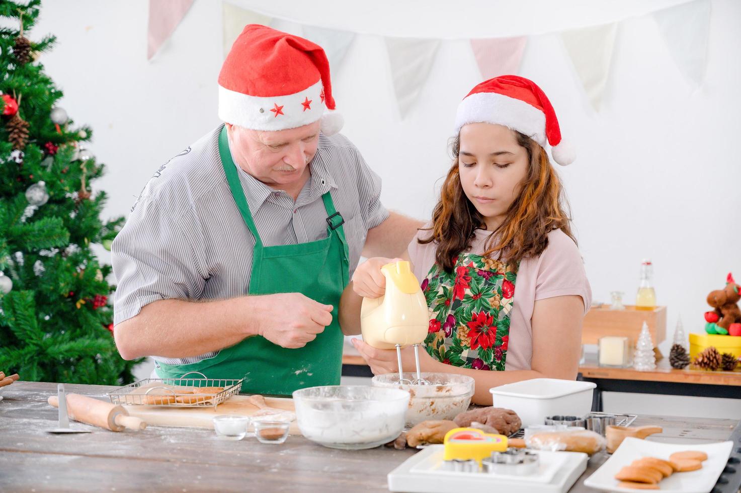 una giovane ragazza europea e suo padre stanno preparando gli ingredienti per cuocere il pan di zenzero foto