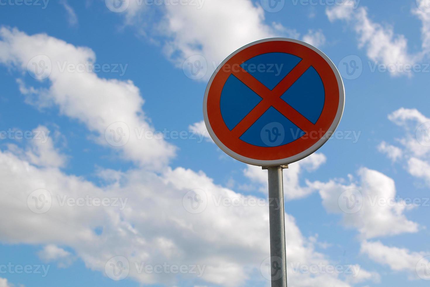 segnale stradale di divieto di parcheggio. il segno della superstrada urbana con sfondo azzurro del cielo nuvoloso. foto