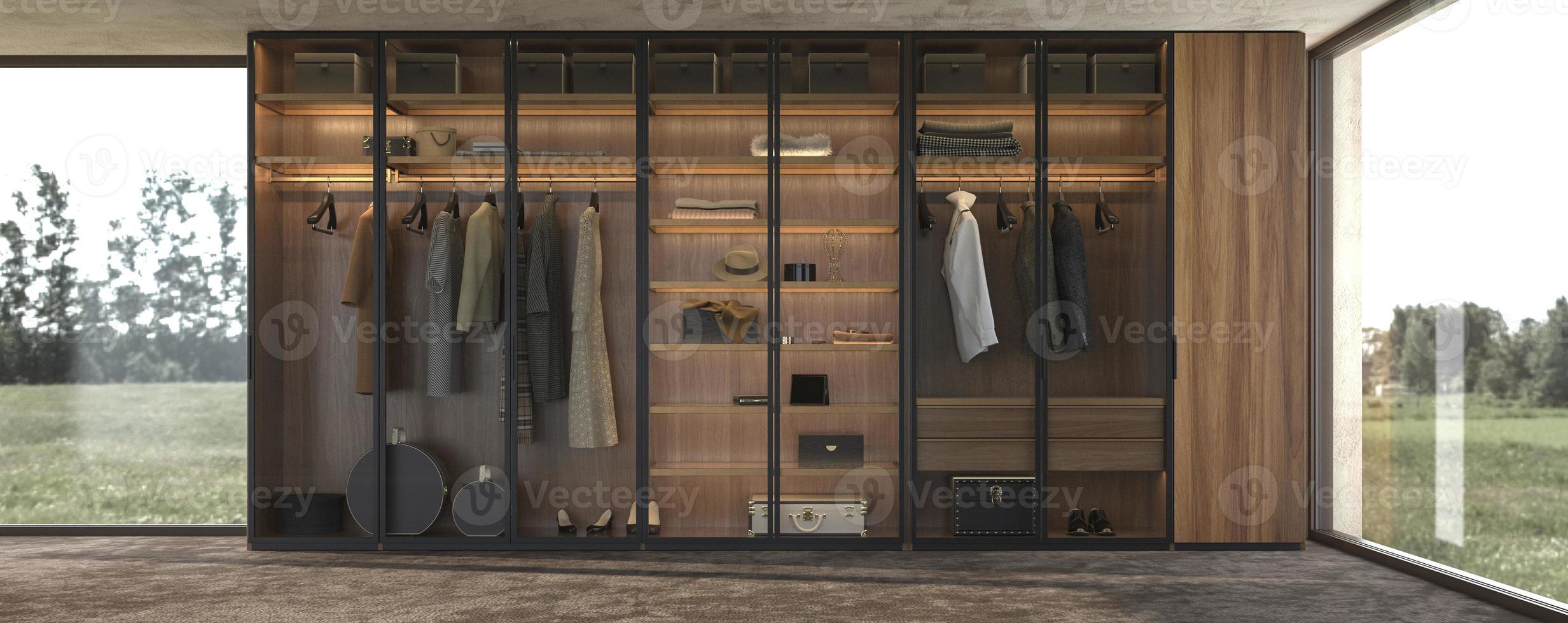 interni di lusso dal design moderno e grande armadio in legno con vestiti appesi su binario nella cabina armadio e illuminazione dello scaffale foto