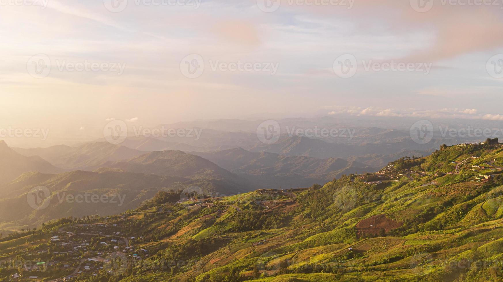 valle di montagna con raggi di sole all'alba colorata in autunno in asia. bellissimo paesaggio naturale con colline nebbiose in autunno foto