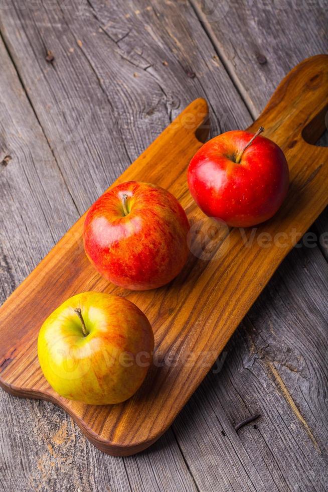 mele fresche sul tagliere di legno foto
