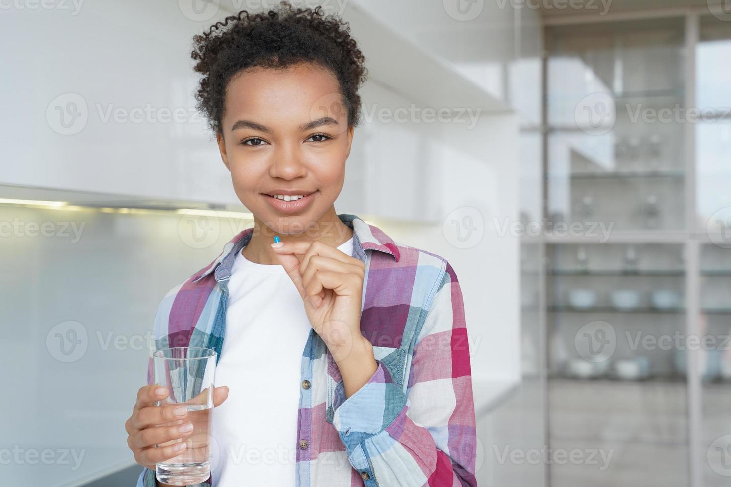 la ragazza afro positiva sta prendendo pillole contraccettive. farmaci e concetto di prevenzione della gravidanza. foto