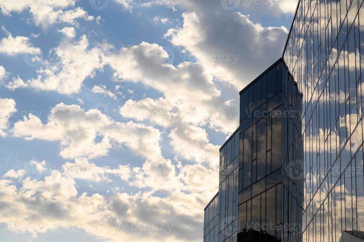 edifici in vetro con sfondo nuvoloso cielo blu foto